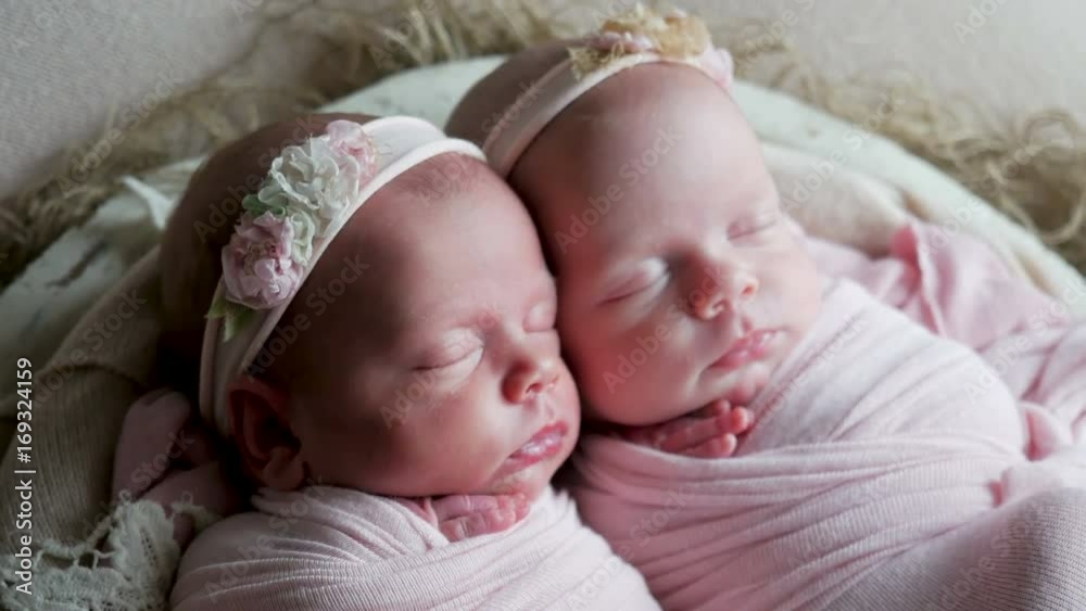 twin babies sleep in the crib in dresses and headband twin babies sleep in the crib in dresses and headband