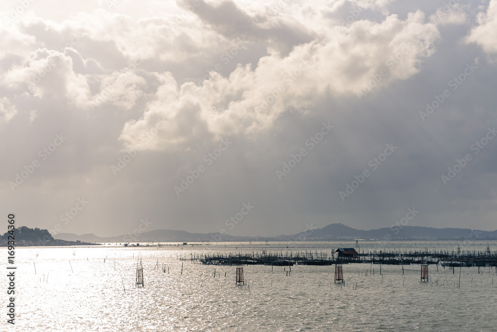 Sun shine through cloud to the hut and fish trap in the Songkhla Lake, Thailand.