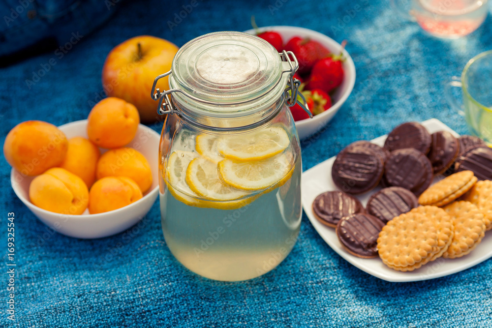 Picnic in the woods. Lemonade, cookies, apricots, strawberries, apples. Family Breakfast in nature. A refreshing drink in a jar. Picnic in the woods. Lemonade, cookies, apricots, strawberries, apples. Family Breakfast in nature. A refreshing drink in a jar.