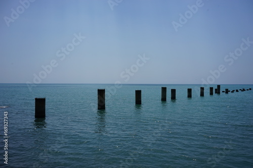 support the old ruined pier in the calm blue sea © vvicca
