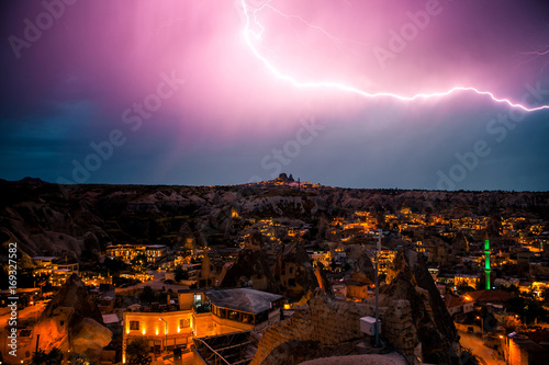 Lightning above the town of Goreme in Cappadocia in Turkey. Dramatic night sky, storm.