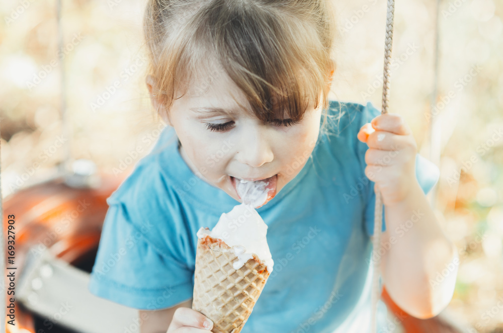 Beautiful girl five years eating ice cream in nature Beautiful girl five years eating ice cream in nature