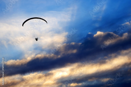 Paramotor Fly on Cloudy Sunset © JavierD