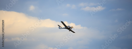 Fotografie Small plane on blue sky background