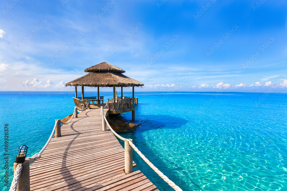Beautiful summer tropical beach landscape, wooden pier, turquoise sea water