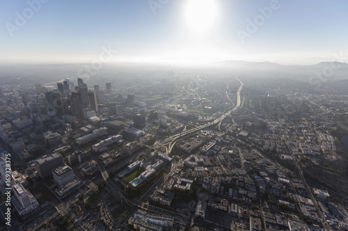 Hazy summer afternoon aerial view of urban downtown Los Angeles streets and towers. 