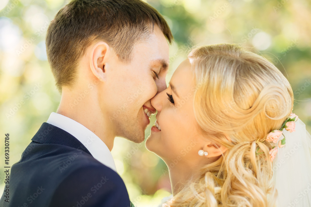 Closeup of beautiful happy couple kissing in the park Closeup of beautiful happy couple kissing in the park