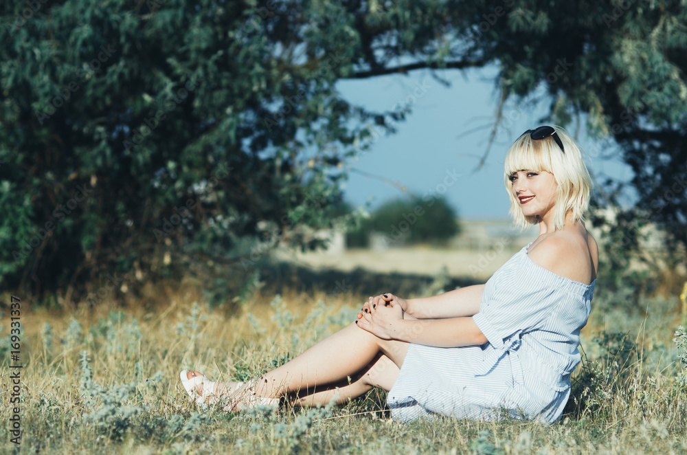 Charming blonde girl in the woods