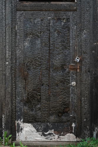 Burned wooden door, vertical texture