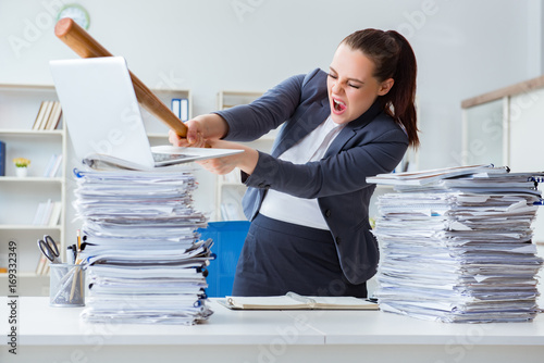 Photography Angry businesswoman with baseball bat in office