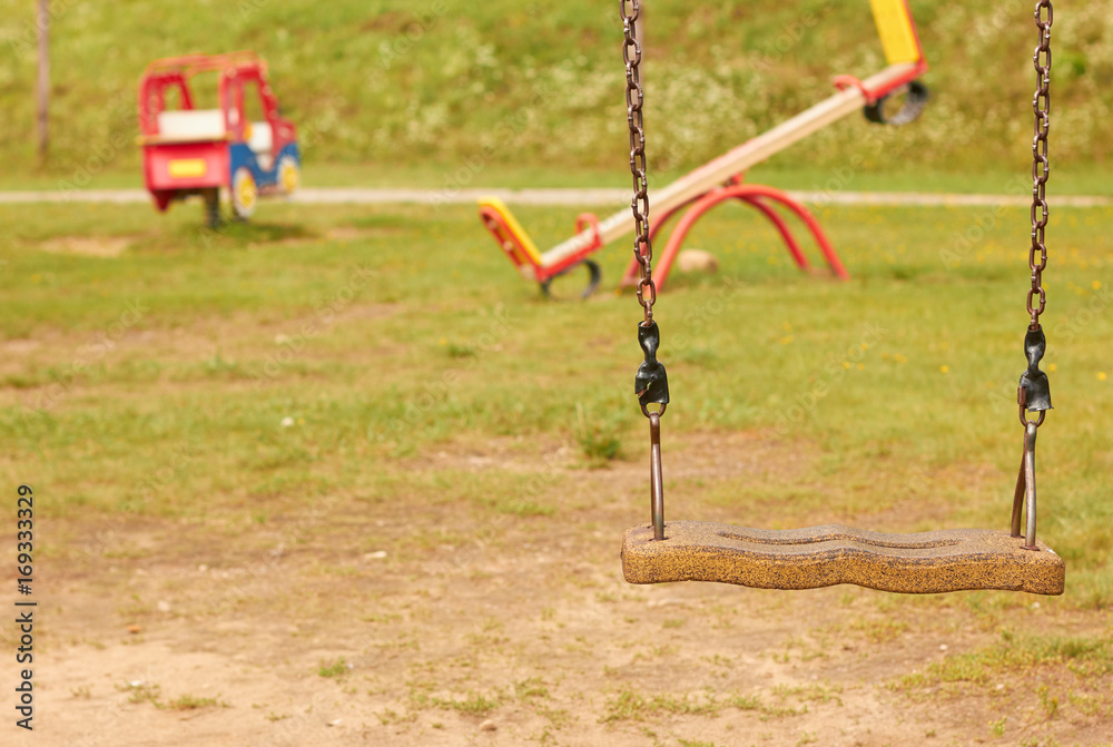 Playground in the kindergarten. Summer, sun, swings and slides Playground in the kindergarten. Summer, sun, swings and slides