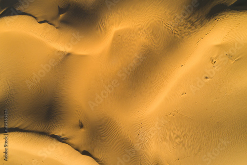 Sandy desert texture. Lines and pattern. Aerial top vertical shot.