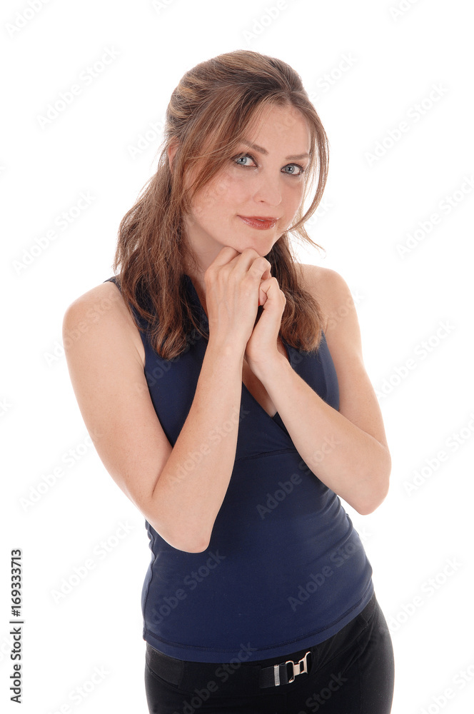 Woman standing with her hands under her chin Woman standing with her hands under her chin