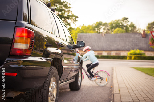 Accident. Girl on the bicycle crosses the road in front of a car