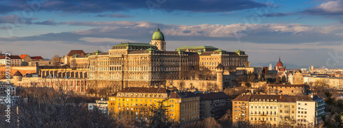 Budapest, Hungary - Panoramic skyline view of the beautiful Buda Castle Royal Palace with parliament of Hungary at sunset with blue sky and clouds