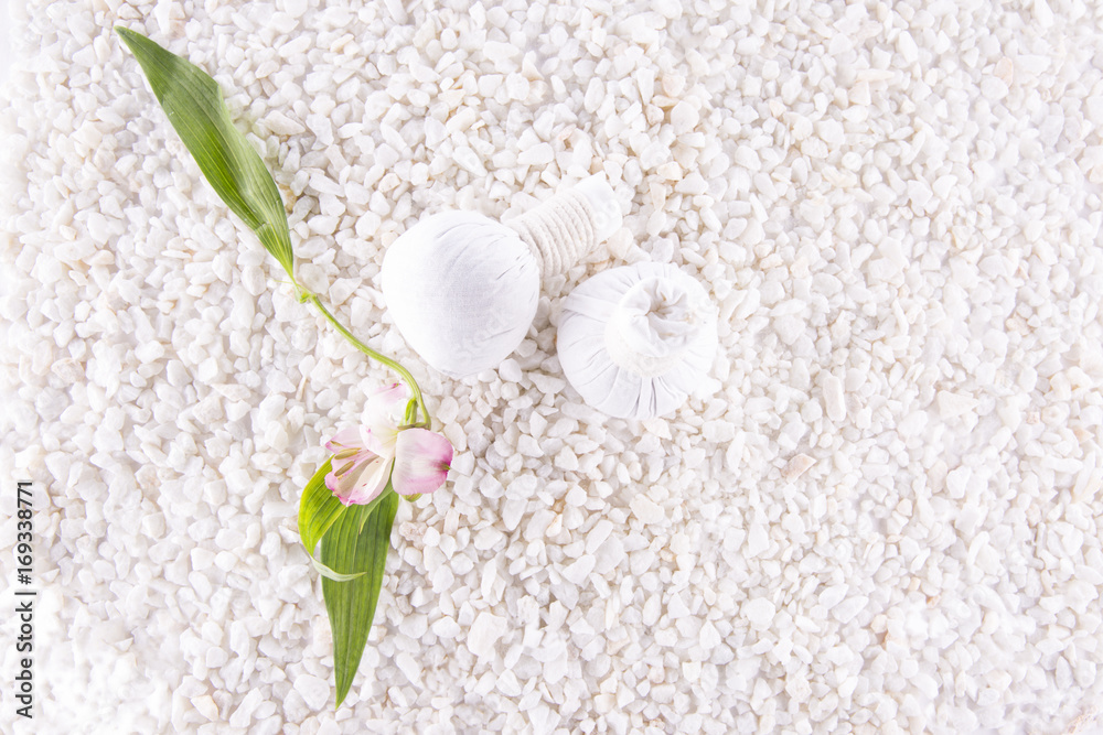 Alstroemeria and floral balls on a background of white pebbles.