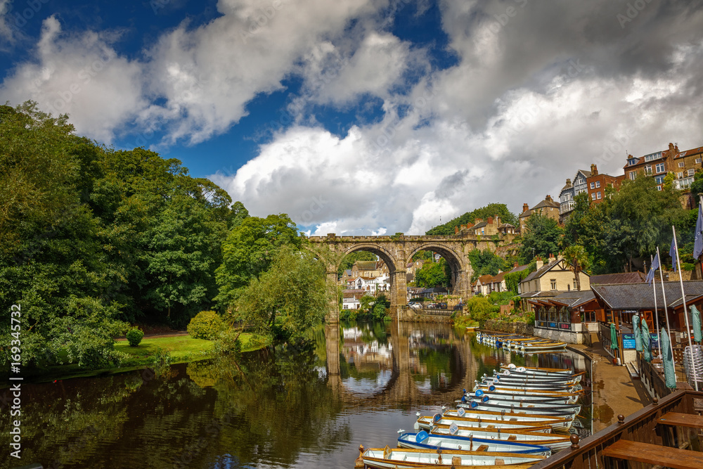 Low-angle telephoto shot of the medieval town of Knaresborough, Yorkshire, England, UK showing the railway viaduct and river Nidd