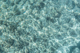 Textured background. Transparent turquoise sea water, natural background. Emerald Coast, Sardinia, Italy.