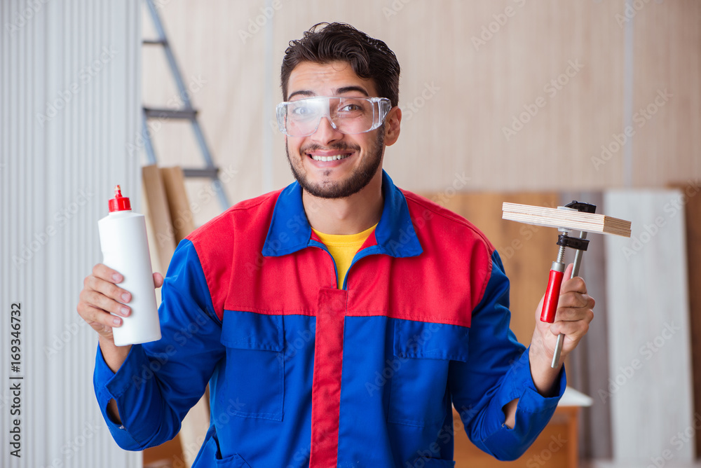 Yooung repairman carpenter working with paint painting