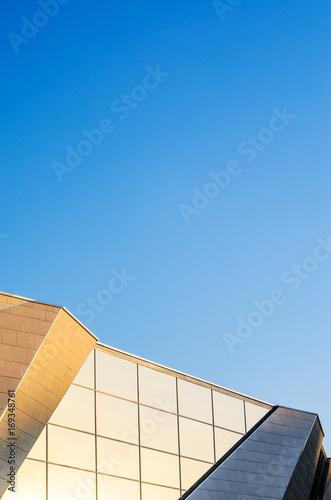Element of the facade of a modern building against a blue clear sky. Empty space for text background. Abstract Architecture Background