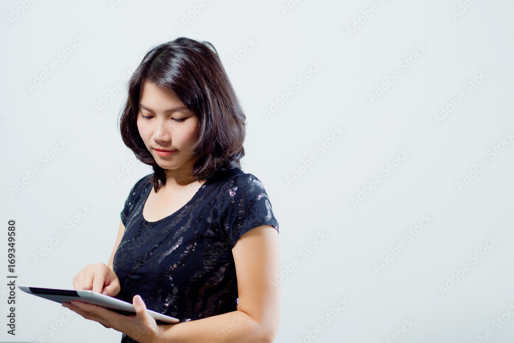 woman playing tablet / finger touch on screen / business concept