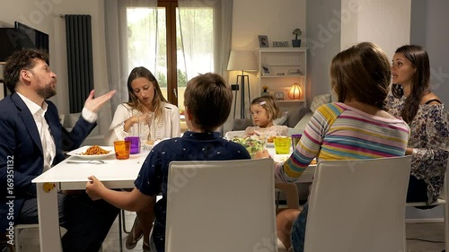Parents at the table with family fighting strong about education of children