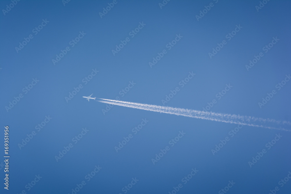 airplane flying high in the sky with vapor trails airplane flying high in the sky with vapor trails