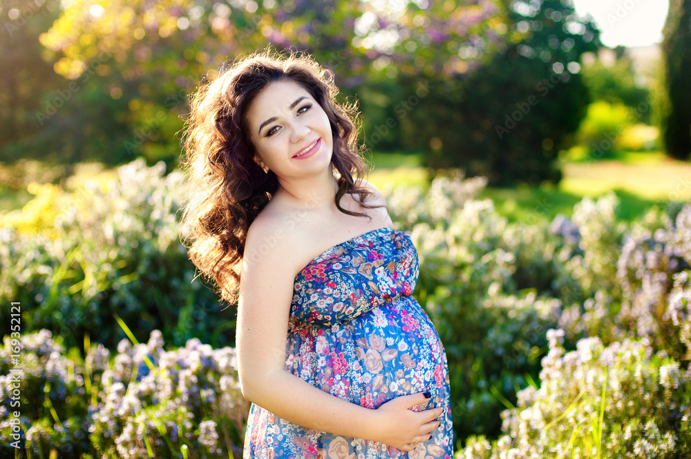 Beautiful pregnant woman in a sunset outside in the park. Beautiful pregnant woman in a sunset outside in the park.