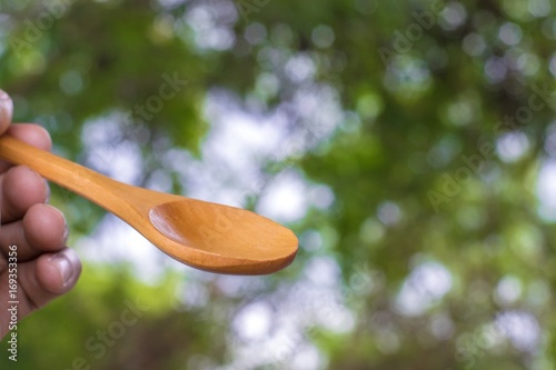 Wooden spoon on tree blurred background.Using food composition image.For food with candy and snacks image to package with products and delicious taste.