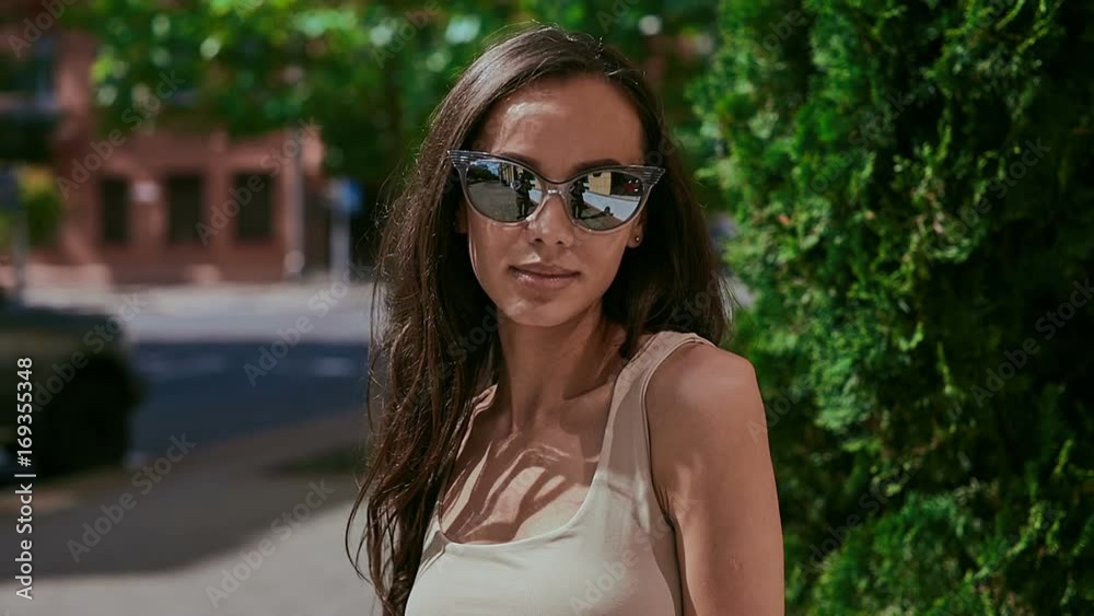 Cute and gorgeous latin women in dress posing along bright streets Cute and gorgeous latin women in dress posing along bright streets