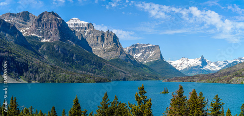 Saint Mary Lake - A panoramic spring view of Saint Mary Lake and its surrounding steep mountains, seen from Going-To-The-Sun Road, in Glacier National Park, Montana, USA. photo