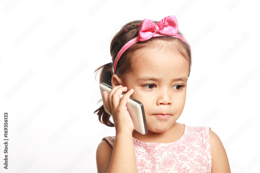 Little girl speaking by cell phone on white background. Little girl speaking by cell phone on white background.