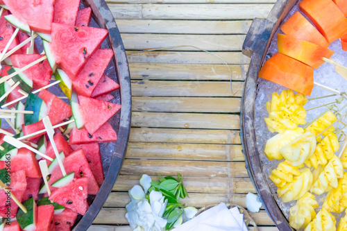 Pineapple and papaya fruit on ice. Fresh fuirt. photo