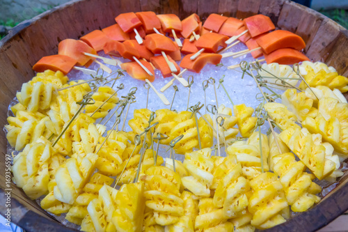 Pineapple and papaya fruit on ice. Fresh fuirt. photo