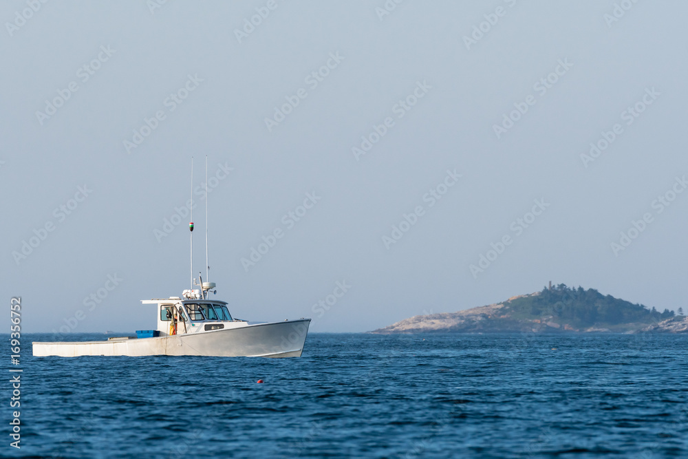 Lobster men hard at work on a beautiful morning in early autumn in South Bristol, Maine, United States
