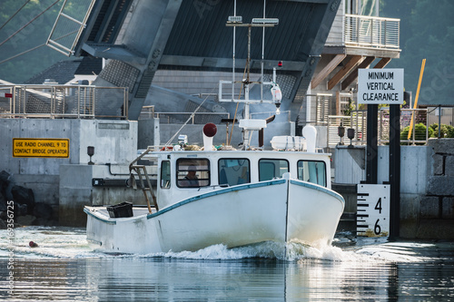 Lobster boat heads out for a beautiful days work in South Bristol, Maine, United States