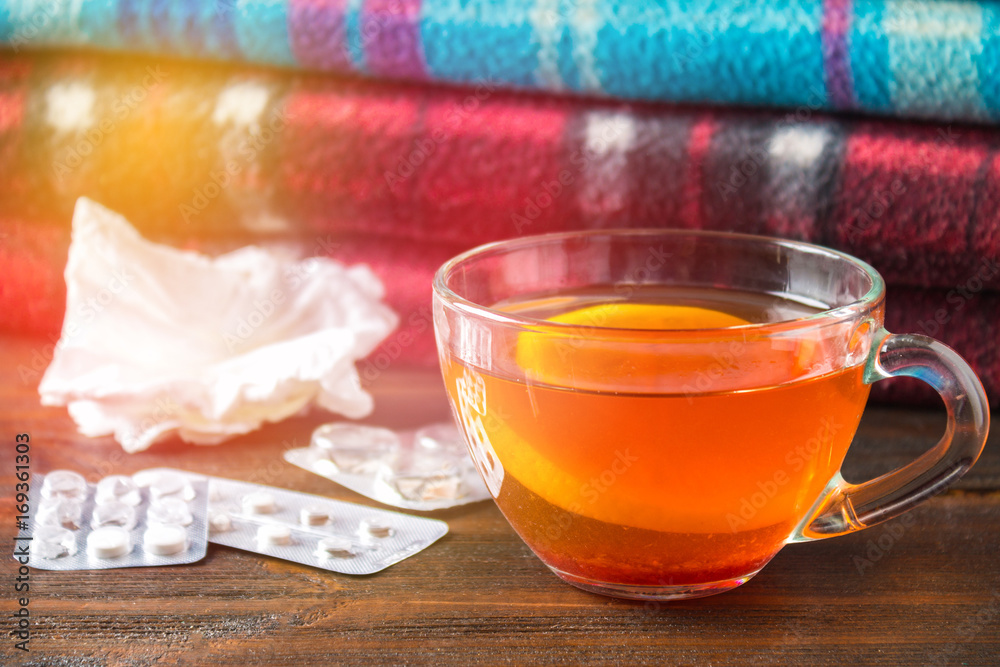 Fototapeta premium Drugs for colds - pills, spray. Folk remedies - lemon, tea, raspberry jam. Thermometer, handkerchiefs. Treatment of illness, influenza.