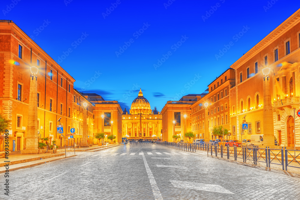 St. Peter's Square and St. Peter's Basilica, Vatican City in the evening time from street Conciliazione (Via della Conciliazione ).