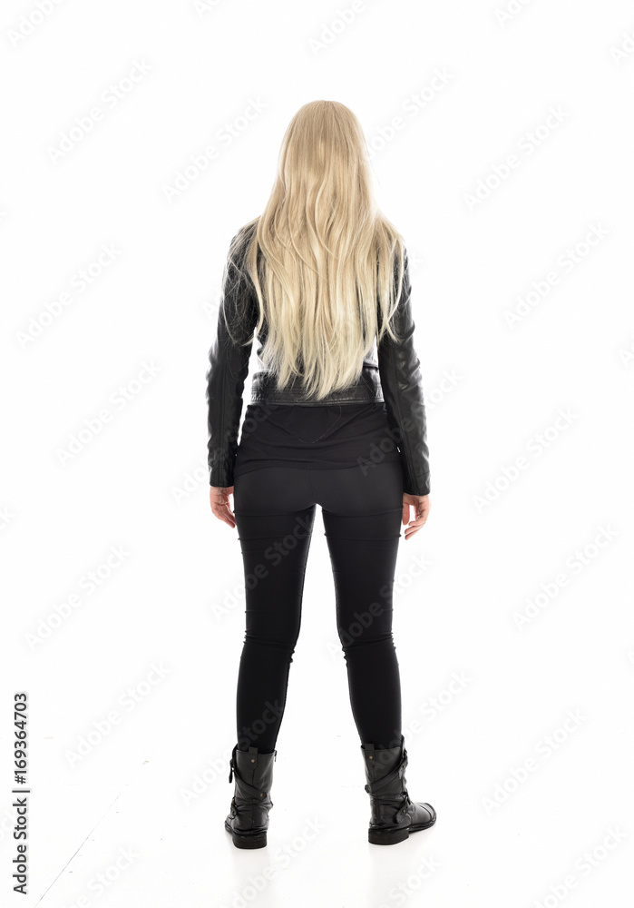 full length portrait of blonde girl wearing black leather outfit, standing pose on white background. full length portrait of blonde girl wearing black leather outfit, standing pose on white background.
