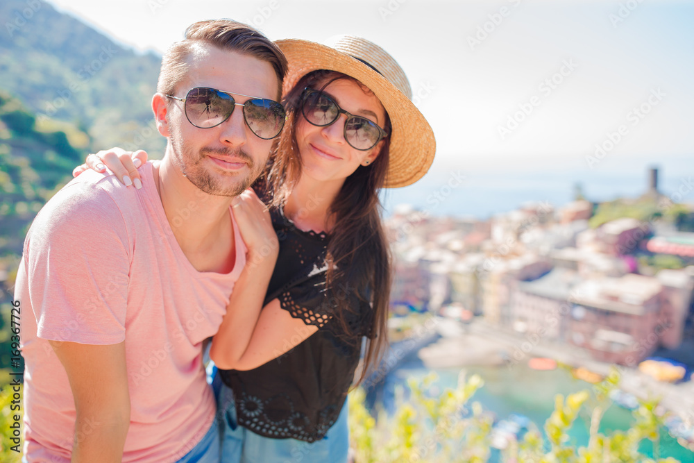 Naklejka premium Happy couple with view of the old coastal village, Cinque Terre national park, Liguria, Italy ,Europe