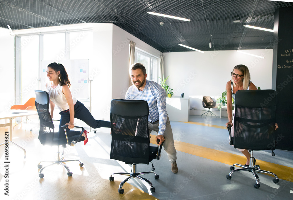 Business people riding a chair and racing in the workplace. Business people riding a chair and racing in the workplace.
