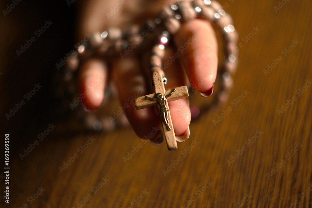 Obraz premium Woman Praying With Rosary Beads In Hand