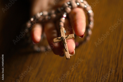 Woman Praying With Rosary Beads In Hand