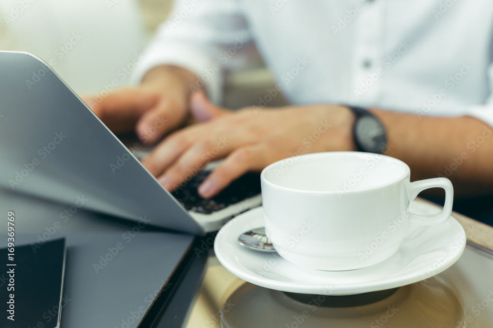 Young man performs work on a laptop Young man performs work on a laptop