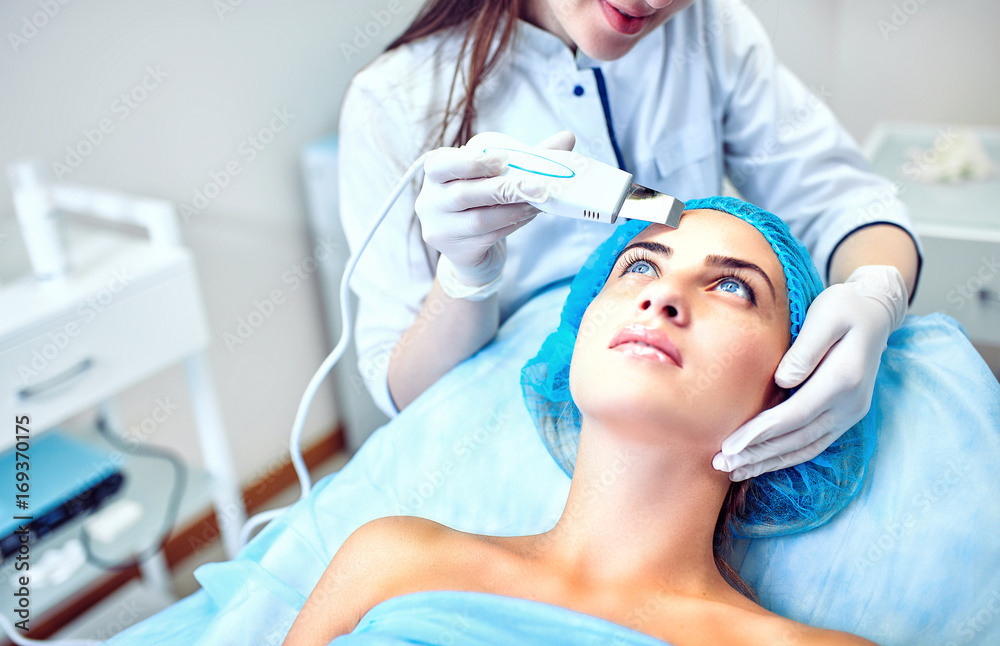 Naklejka premium A woman cosmetologist at work in the hospital.