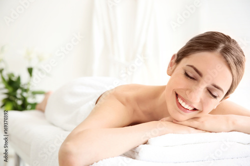 Young beautiful woman relaxing in spa salon