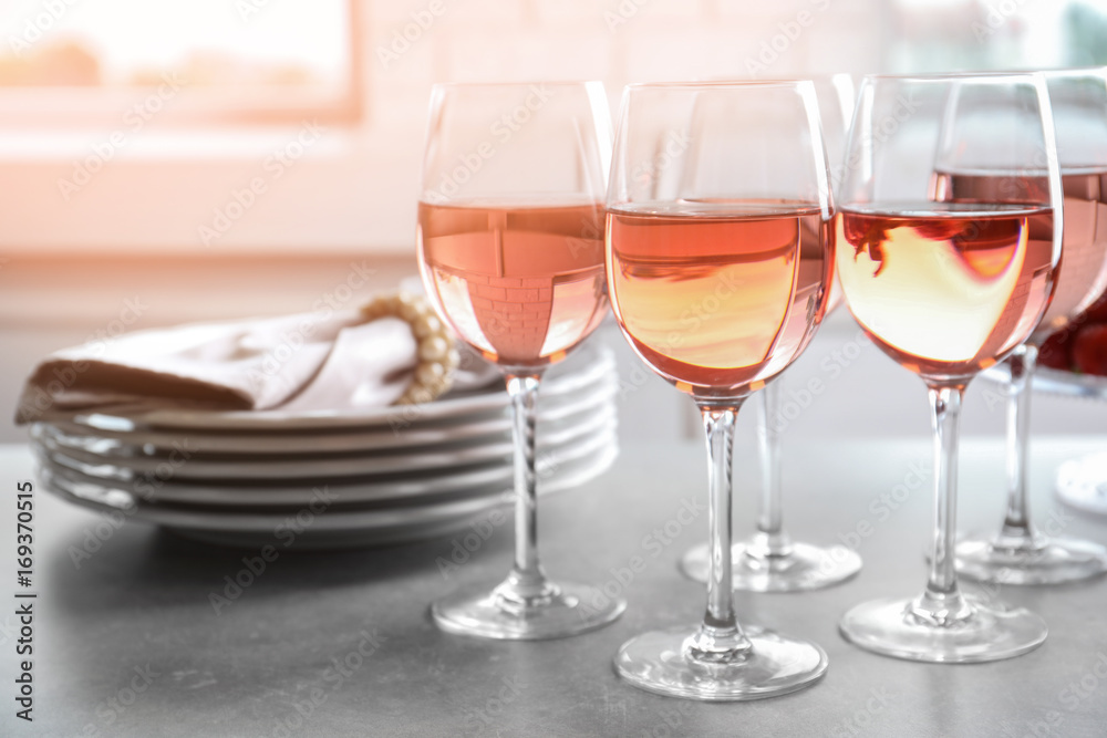 Glasses of strawberry wine on table Glasses of strawberry wine on table