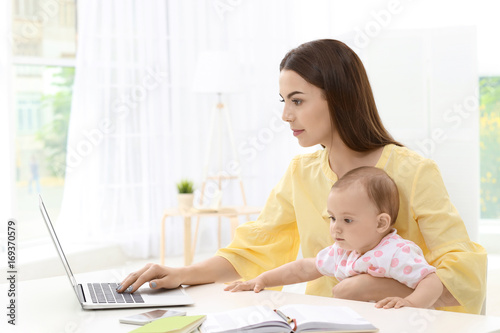 Young mother holding baby w...