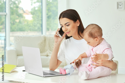 Young mother holding baby w...