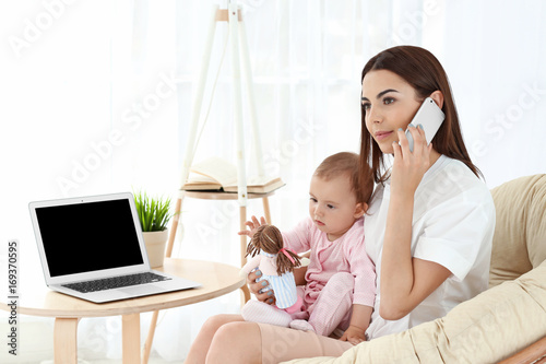 Young mother holding baby w...